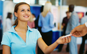 girl handing out cards