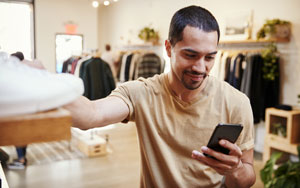 guy looking at phone in store