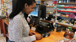 cashier counter with woman swiping card