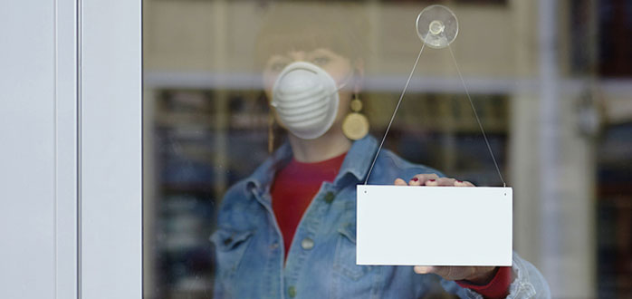 woman at storefront with covid mask