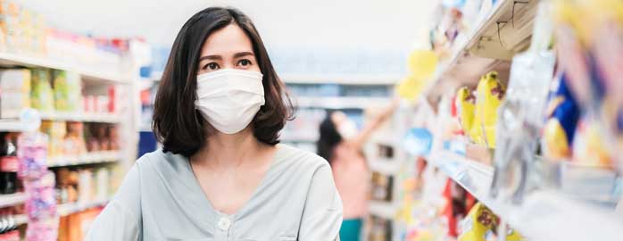 masked woman shopping in store