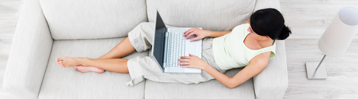 woman sitting on a couch with a laptop