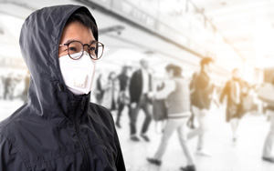 man in crowd with mask