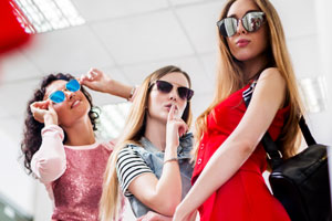 girls wearing sunglasses and shopping