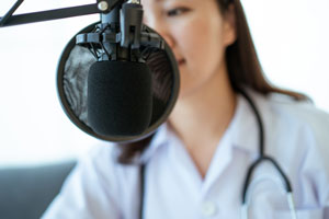 woman talking into microphone on a podcast