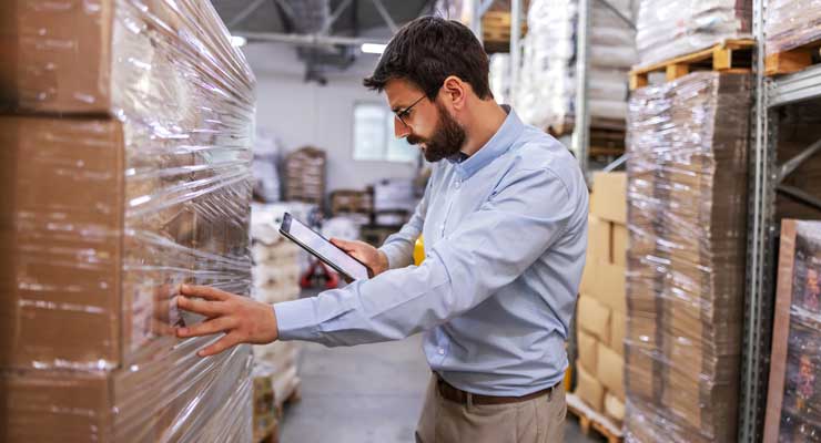 manager checking pallets in warehouse